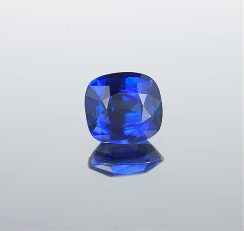 Cushion-cut sapphire on dark background